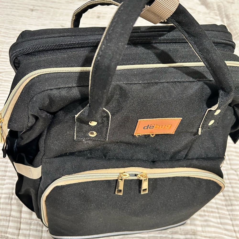 Debug diaper bag with changing station.